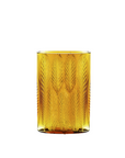 Yellow crystal tumbler with a textured fern pattern on a white background