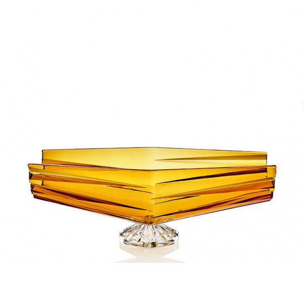 Amber-colored square crystal bowl with a clear base on a white background