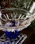 Crystal bowl with blue center on a wooden surface