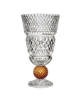 Crystal vase with amber sphere on a white background from Mario Cioni at Spacio store in India. 