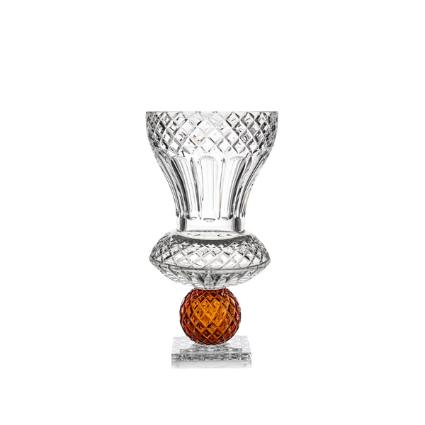 Crystal glass with an amber base on a white background