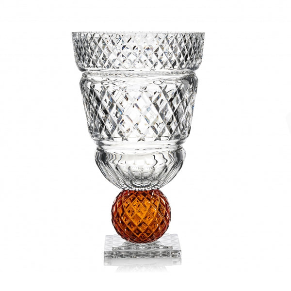 Crystal vase with amber sphere on a white background from Mario Cioni at Spacio store in India. 