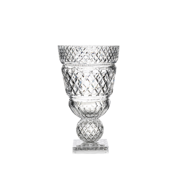 Clear glass vase with diamond cut pattern on a white background