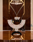 Decorative crystal object on a table with a blurred background