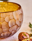 Decorative stone-patterned crystal bowl on a table.