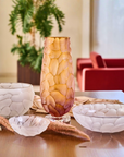Decorative crystal vases and bowls on a table with a blurred indoor background