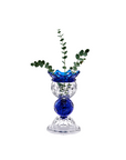 Decorative crystal vase with blue and clear design with greens on a white background