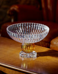 Crystal bowl with a yellow base on a wooden surface
