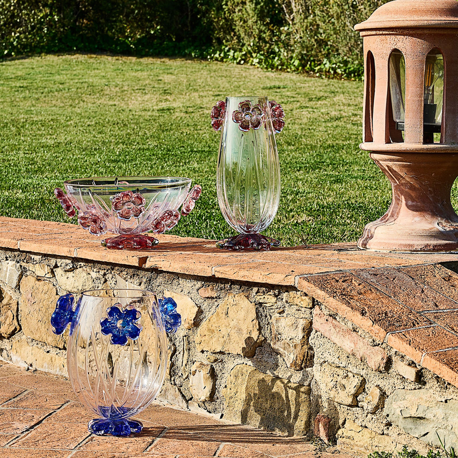 A pair of Handcrafted Mario Cioni Cistus Crystal Vases placed outdoors, featuring intricate red flower accents and elegant detailing for luxury decor.