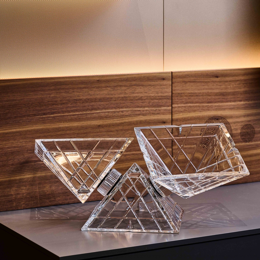 Mario Cioni Crystal Pyramidion Centerpiece Bowl by Tondo Doni on a plane surface in a interior space available at Spacio India for luxury home decor accessories collection of Bowls.