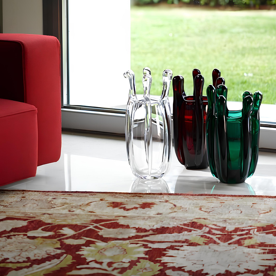 Mario Cioni Crystal Green Liquid Mood Vase by Tondo Doni with Red & Clear Vases on floor beside Sofa set in interior available at Spacio India for luxury home decor accessories collection of decorative Vases. 