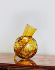 Mario Cioni Crystal Vulcano Amber Vase by Tondo Doni on a wooden table surface available at spacio india for luxury home decor collection of decorative vases.