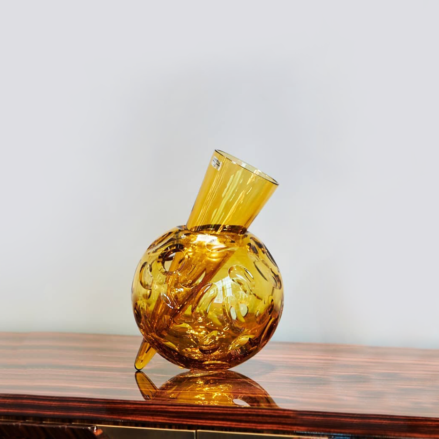 Mario Cioni Crystal Vulcano Amber Vase by Tondo Doni on a wooden table surface available at spacio india for luxury home decor collection of decorative vases.