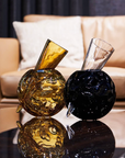 Mario Cioni Crystal Vulcano Amber Vase by Tondo Doni with other Black Vulcano Vase on a center table in modern living room available at spacio india for luxury home decor collection of decorative vases.