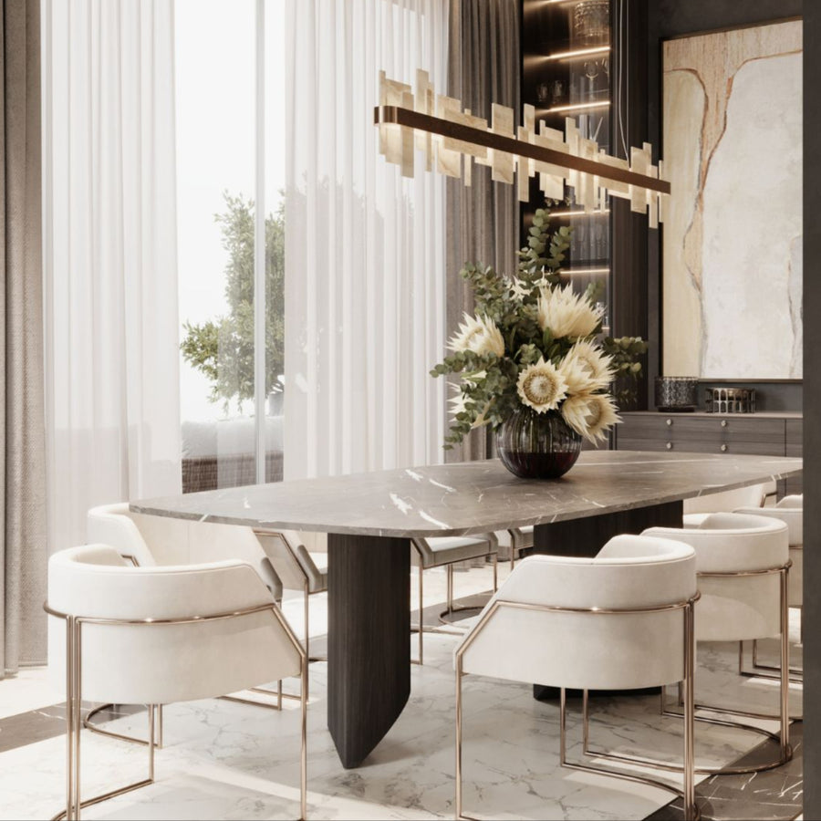 Modern dining room with a marble table and white chairs and an onyx chandelier by Masiero available at Spacio retail stores in Mumbai & Kolkata. 