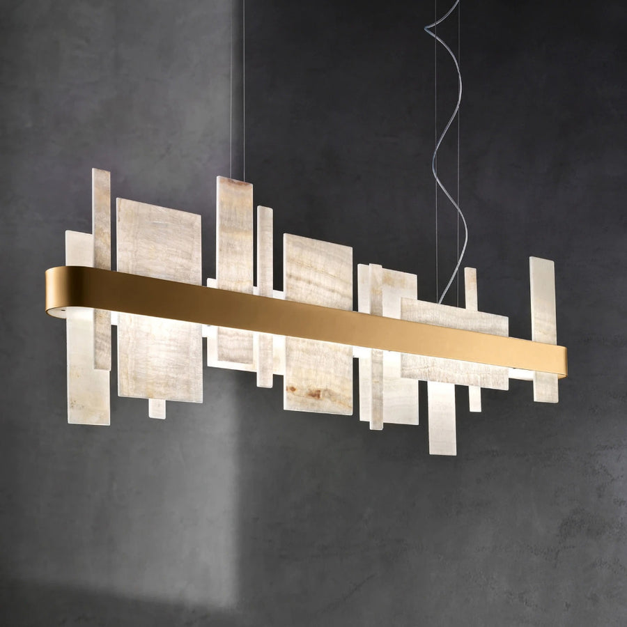 Modern chandelier with gold and white design on a dark background by Masiero available at Spacio retail stores in Mumbai & Kolkata. 