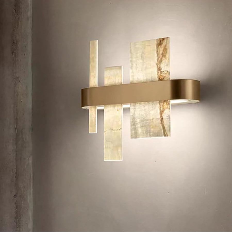 Modern wall lamp with gold and marble finish on a gray wall by Masiero available at Spacio retail stores in Mumbai & Kolkata. 
