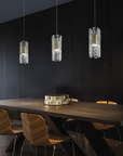 A dining room with opulent black table and chairs adorned with decorative lighting from the Masiero Vegas Pendant Lamp by Masiero.