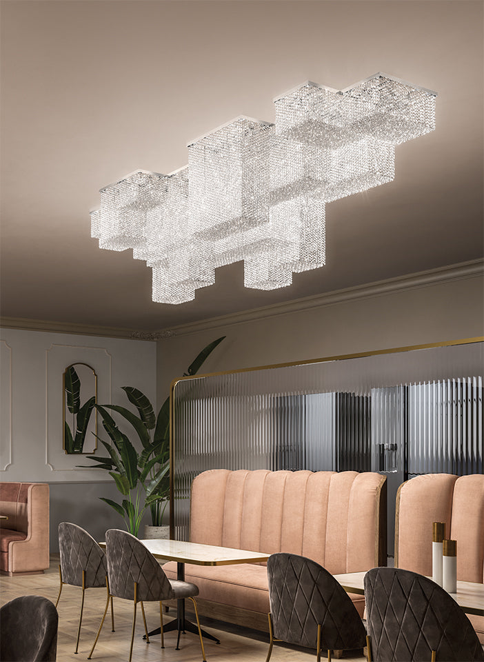 Modern chandelier hanging in a stylish interior setting with furniture and decor.