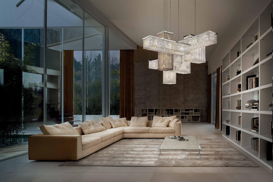 Modern living room with a chandelier, sofa, and bookshelf.