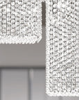Crystal chandelier hanging from the ceiling with a blurred background