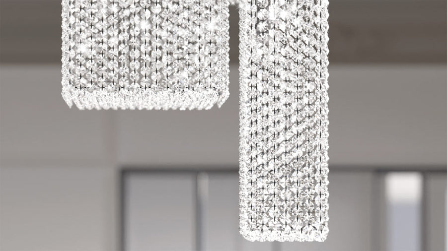 Crystal chandelier hanging from the ceiling with a blurred background