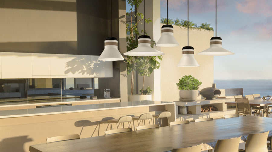 Modern outdoor kitchen with dining area and ocean view with white colour outdoor pendant lights from Masiero above the dining table