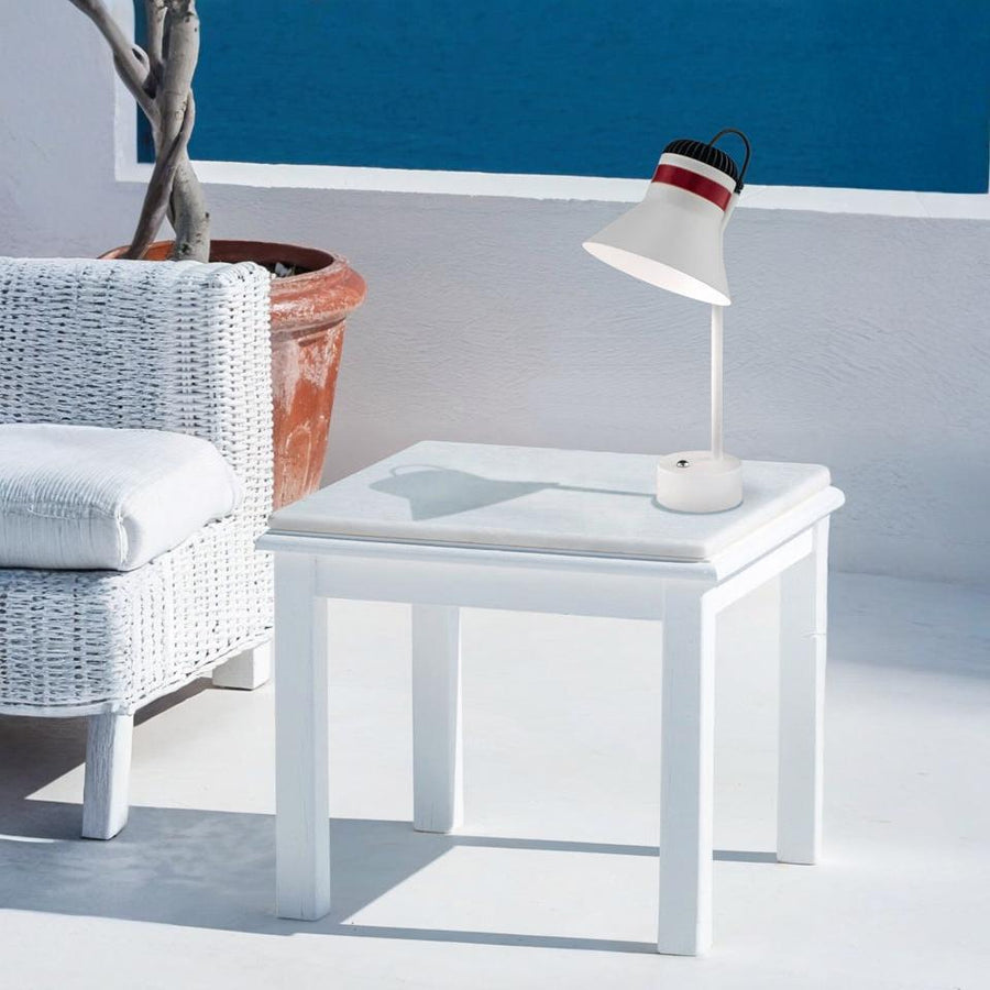 White side table with a rechargeable table lamp from Masiero and plant in a minimalistic room.