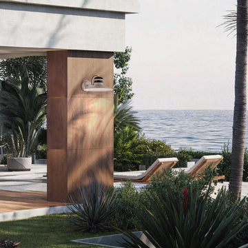 Ocean view and lounge chairs with Masiero's Cordea outdoor light on the wall in white colour