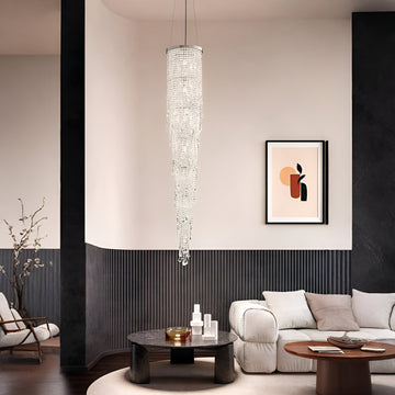 Modern living room with a crystal chandelier, sofa, and wall art.