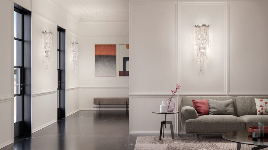 Modern living room with a gray sofa, coffee table, and wall art with Masiero Cristalle wall lights