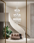 Double height Chandelier hanging above a modern living room with a curved staircase.