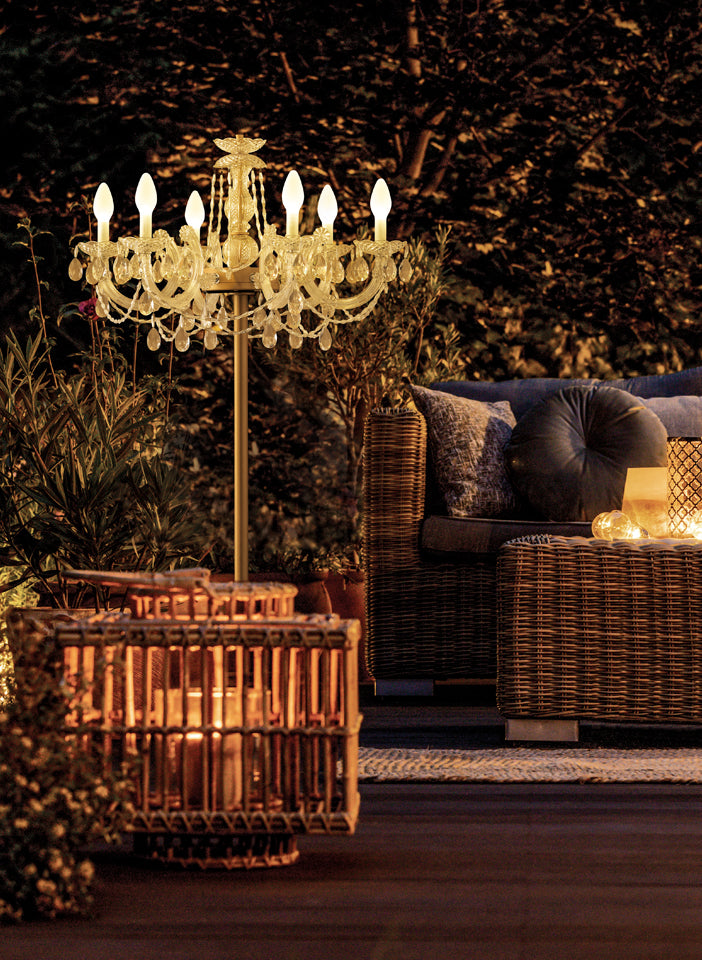 Decorative Table chandelier in an outdoor setting with a couch and lanterns.