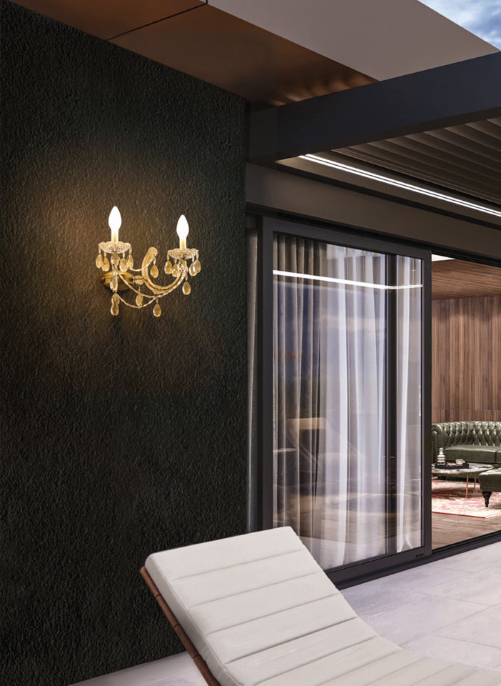 Outdoor Gold wall sconce on a dark wall with a modern interior setting