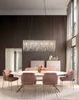 Modern dining room with a crystal chandelier from Masiero, table, and chairs.