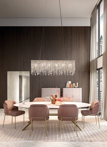 Modern dining room with a crystal chandelier from Masiero, table, and chairs.