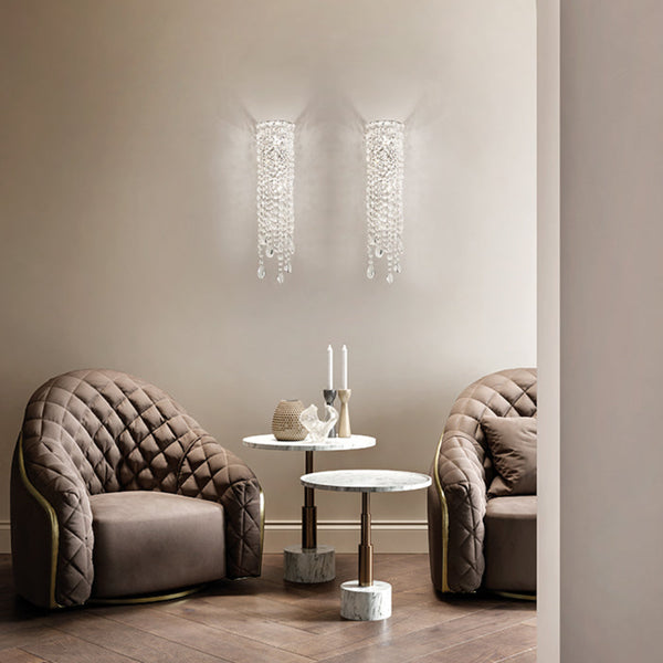 Modern interior with two upholstered chairs and a small table against a neutral wall.