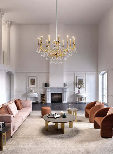 An ornate grade chandelier in a double height living room from Masiero, available at Spacio in India. 