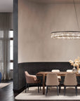 Modern dining room with a table, chairs, and a crystal chandelier from Masiero available at Spacio retail stores in India.