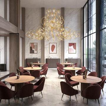 Modern restaurant interior with a grand Raqam chandelier from Masiero, tables, and chairs.