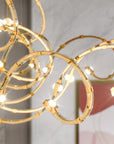 Gold chandelier with circular design in a room setting