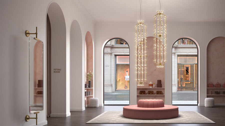 Modern interior design with arched doorways, a pink round ottoman, and hanging crystal lights.