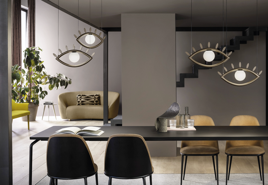 A surreal dining room with a cluster of Eye shaped pendant lights from Masiero Visio Collection table and chairs, where imagination transforms the usual facial geometries into abstract forms. Styled by Spacio Interior Styling team