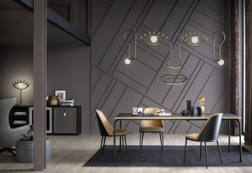 A surrealist dining room that sparks imagination with its black walls, exhibiting facial geometries, and furnished with Masiero Visio Collection