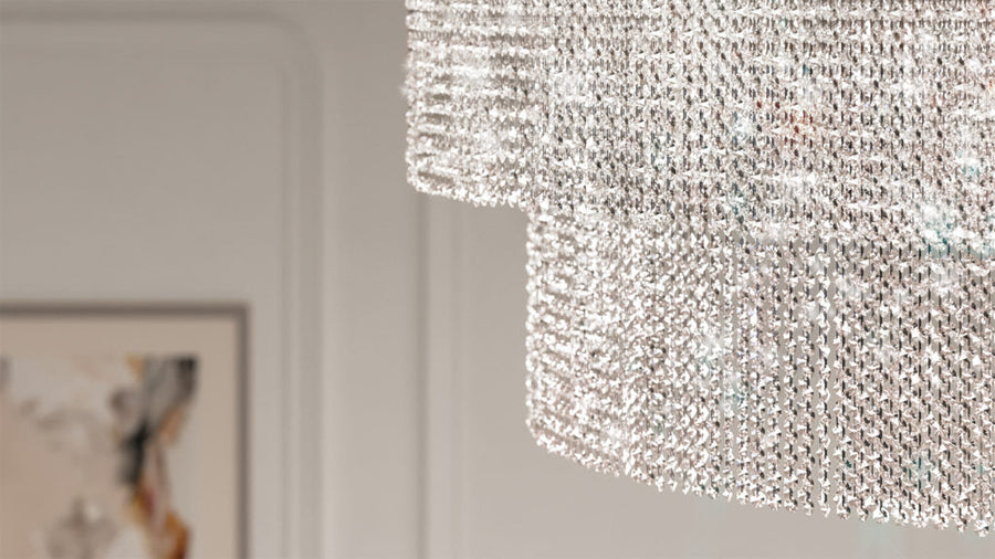 Crystal chandelier hanging from a ceiling in a room with a blurred background