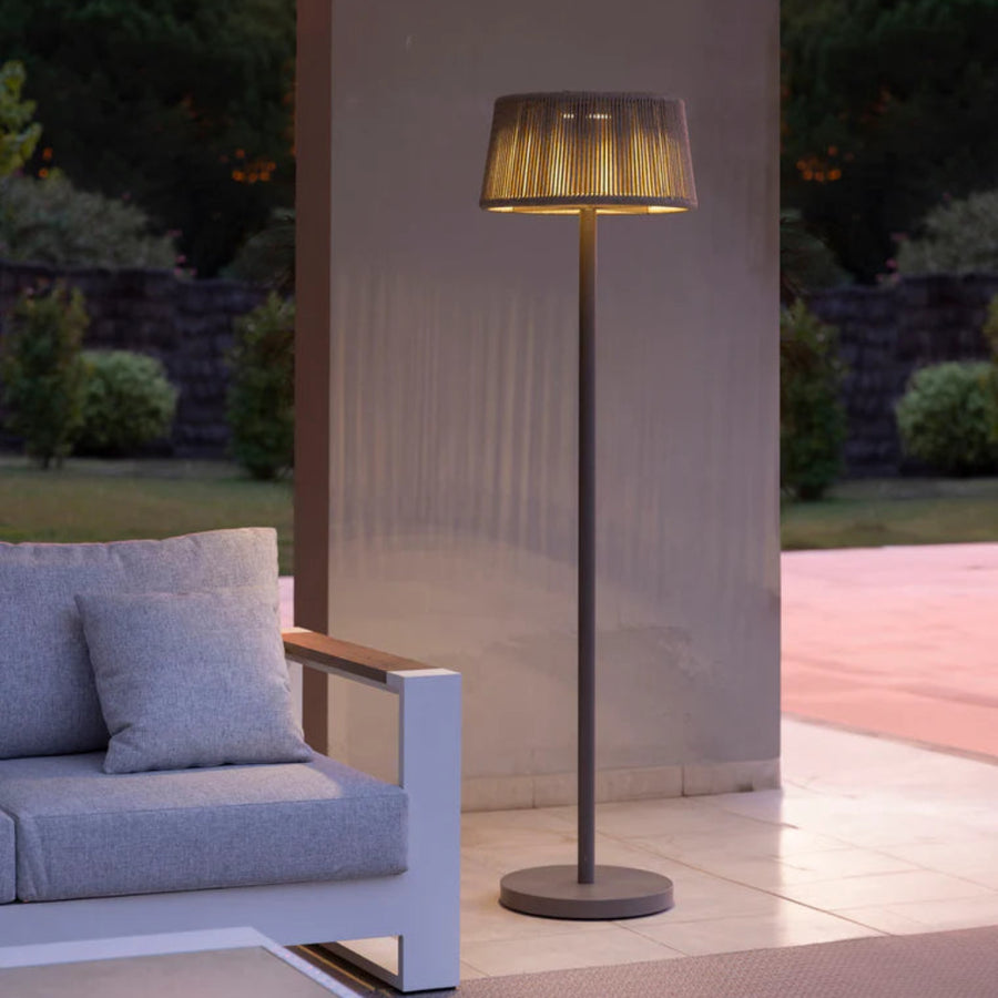 Modern outdoor indoor solar floor lamp next to a sofa in a garden setting by Les Jardins available at Spacio retail stores in Mumbai & Kolkata. 