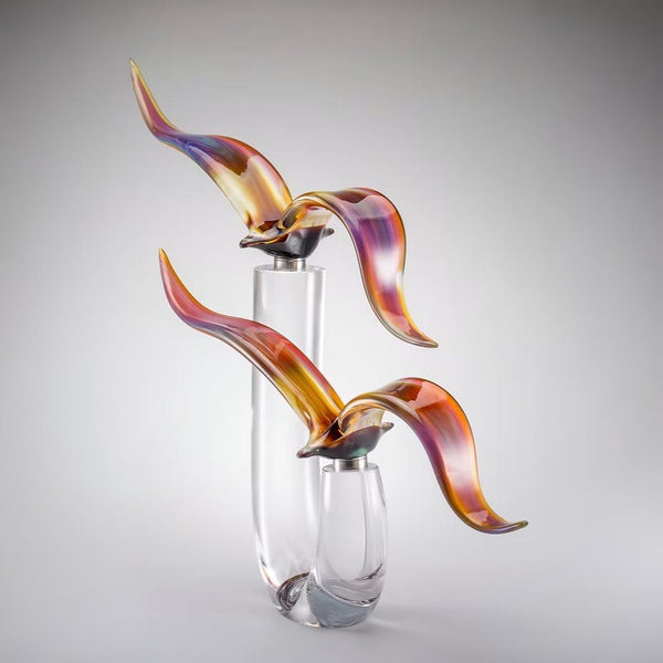Murano Glass sculpture of 2 seagulls on a stand with colorful, wavy design on a gray background by Zanetti at Spacio in India. 