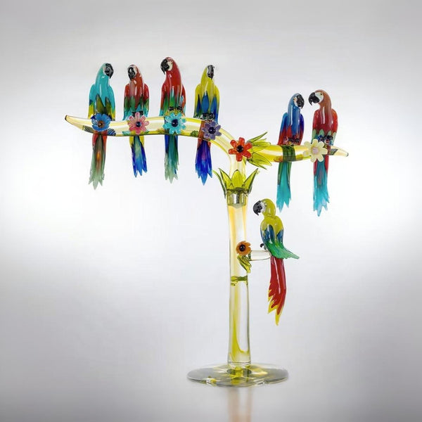 Murano Glass sculpture of seven parrots on a branch with flowers against a gray background by Zanetti at Spacio retail store in Mumbai