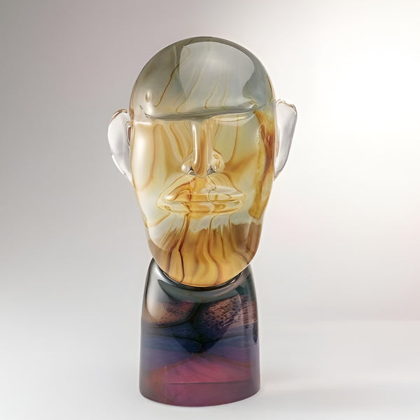 Murano Glass sculpture of a face with a gradient color effect on a white background