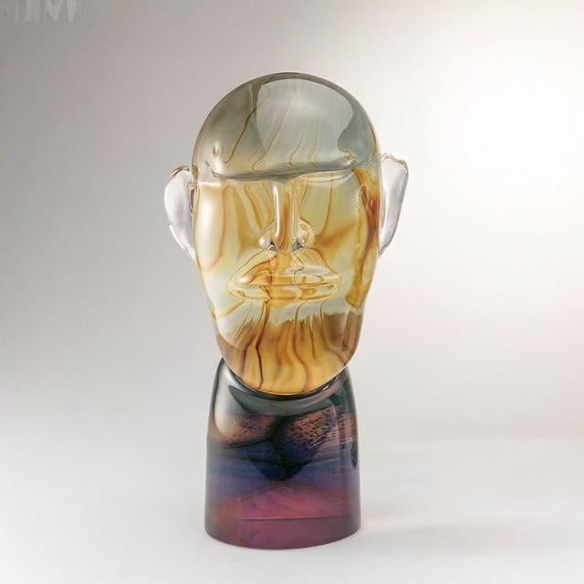 Murano Glass sculpture of a face with a gradient color effect on a white background